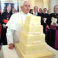 Pope Benedict XVI blow out birthday candle on top of his White House cake for his 81st birthday on April 16